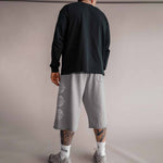 Model von hinten in grauer 3/4 Shorts und schwarzem Longsleeve, Basketball-Streetwear von Tellem